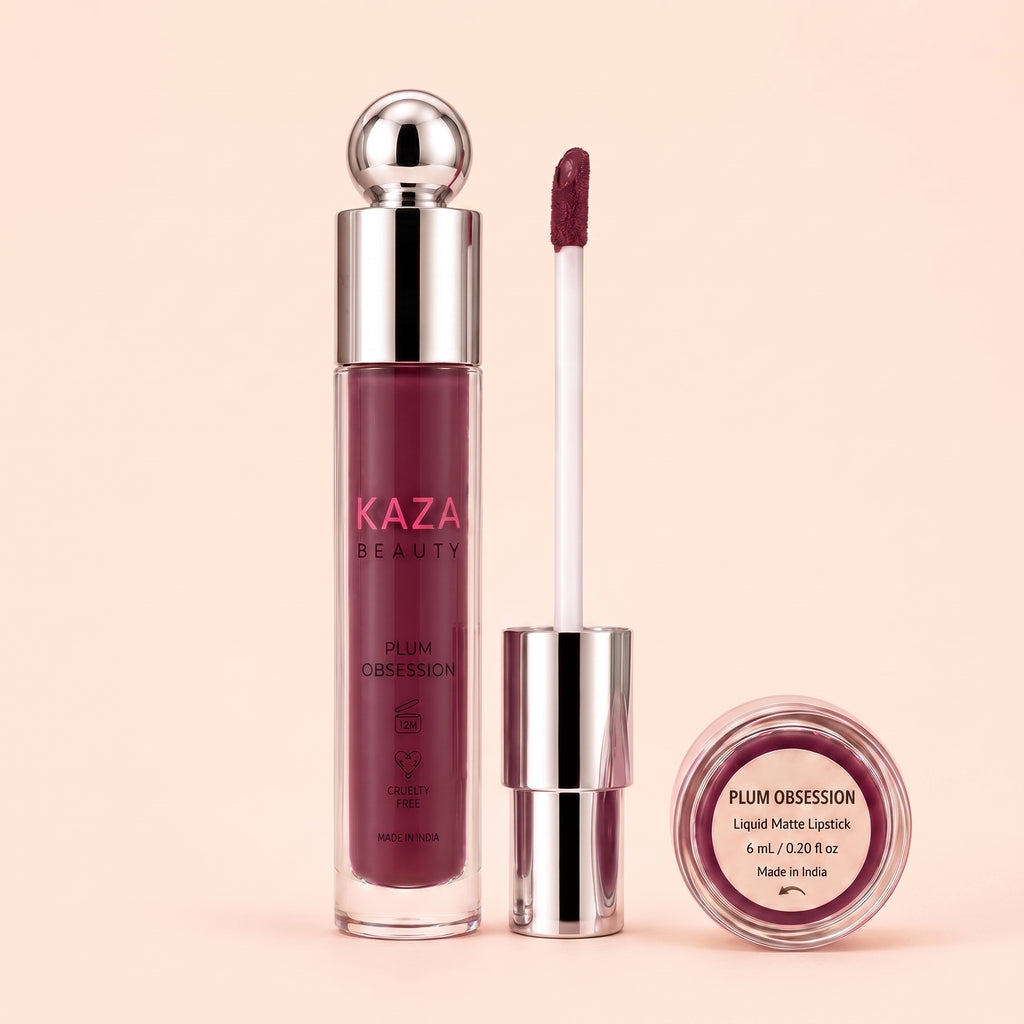 Kaza Beauty Plum Obsession Liquid Matte Lipstick in a deep plum shade, shown with the bottle, applicator wand, and a small round pot on a solid pale peach background.